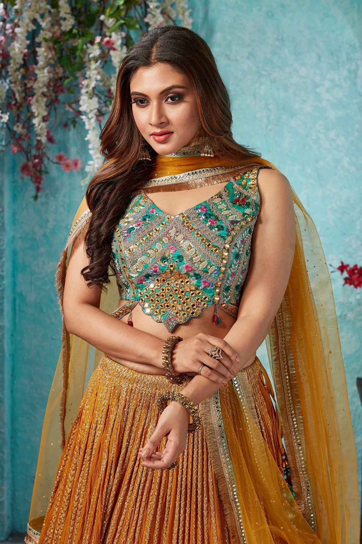 Buy beautiful mustard embroidered georgette lehenga online in USA with embroidered green blouse. Dazzle at weddings and parties in exquisite Indian designerwear dresses, designer lehengas, Anarkali suits, gowns, palazzo suits, sharara suits from Pure Elegance Indian fashion store in USA.-closeup