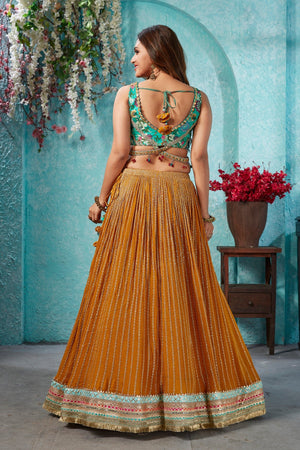 Buy beautiful mustard embroidered georgette lehenga online in USA with embroidered green blouse. Dazzle at weddings and parties in exquisite Indian designerwear dresses, designer lehengas, Anarkali suits, gowns, palazzo suits, sharara suits from Pure Elegance Indian fashion store in USA.-back