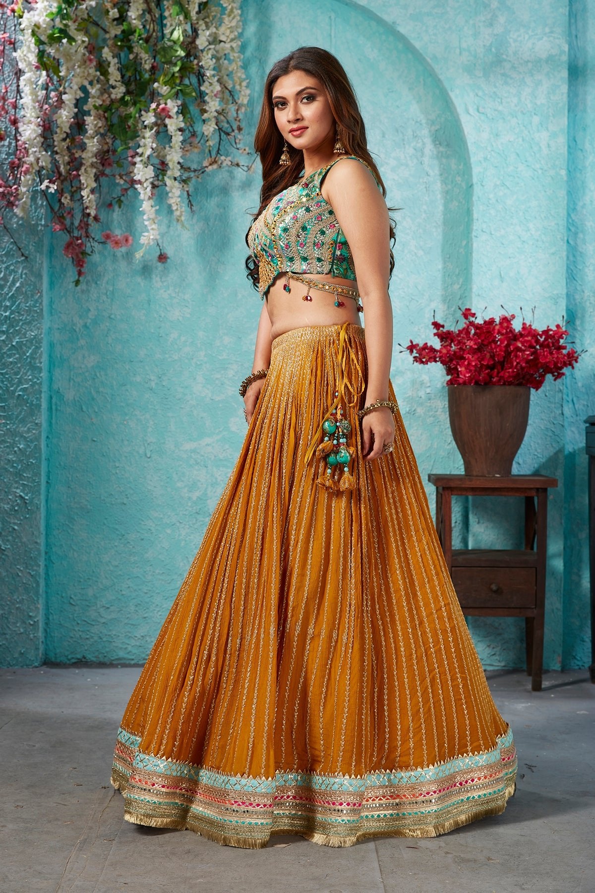 Buy beautiful mustard embroidered georgette lehenga online in USA with embroidered green blouse. Dazzle at weddings and parties in exquisite Indian designerwear dresses, designer lehengas, Anarkali suits, gowns, palazzo suits, sharara suits from Pure Elegance Indian fashion store in USA.-left