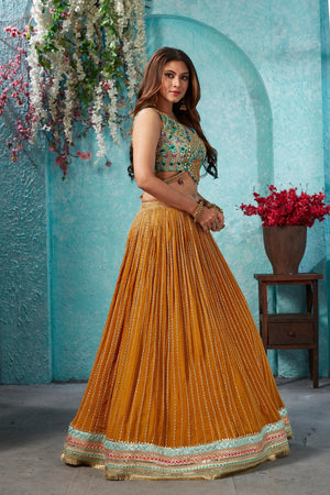 Buy beautiful mustard embroidered georgette lehenga online in USA with embroidered green blouse. Dazzle at weddings and parties in exquisite Indian designerwear dresses, designer lehengas, Anarkali suits, gowns, palazzo suits, sharara suits from Pure Elegance Indian fashion store in USA.-right