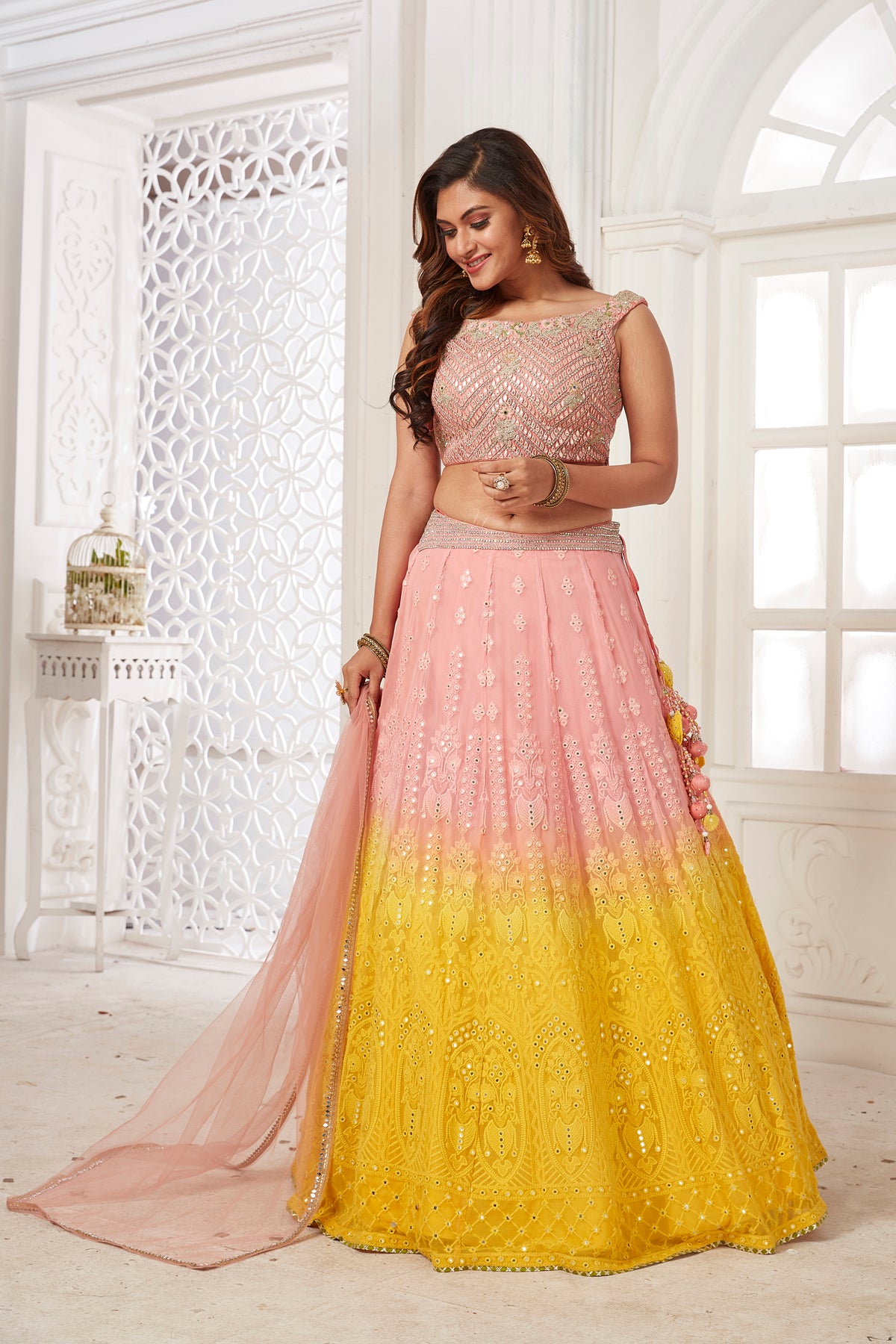 Buy beautiful powder pink and yellow embroidered lehenga online in USA with dupatta. Dazzle at weddings and parties in exquisite Indian designerwear dresses, designer lehengas, Anarkali suits, gowns, palazzo suits, sharara suits from Pure Elegance Indian fashion store in USA.-front