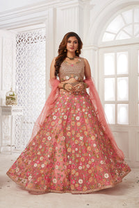 Buy stunning pink embroidered net lehenga online in USA with dupatta. Dazzle at weddings and parties in exquisite Indian designerwear dresses, designer lehengas, Anarkali suits, gowns, palazzo suits, sharara suits from Pure Elegance Indian fashion store in USA.-full view