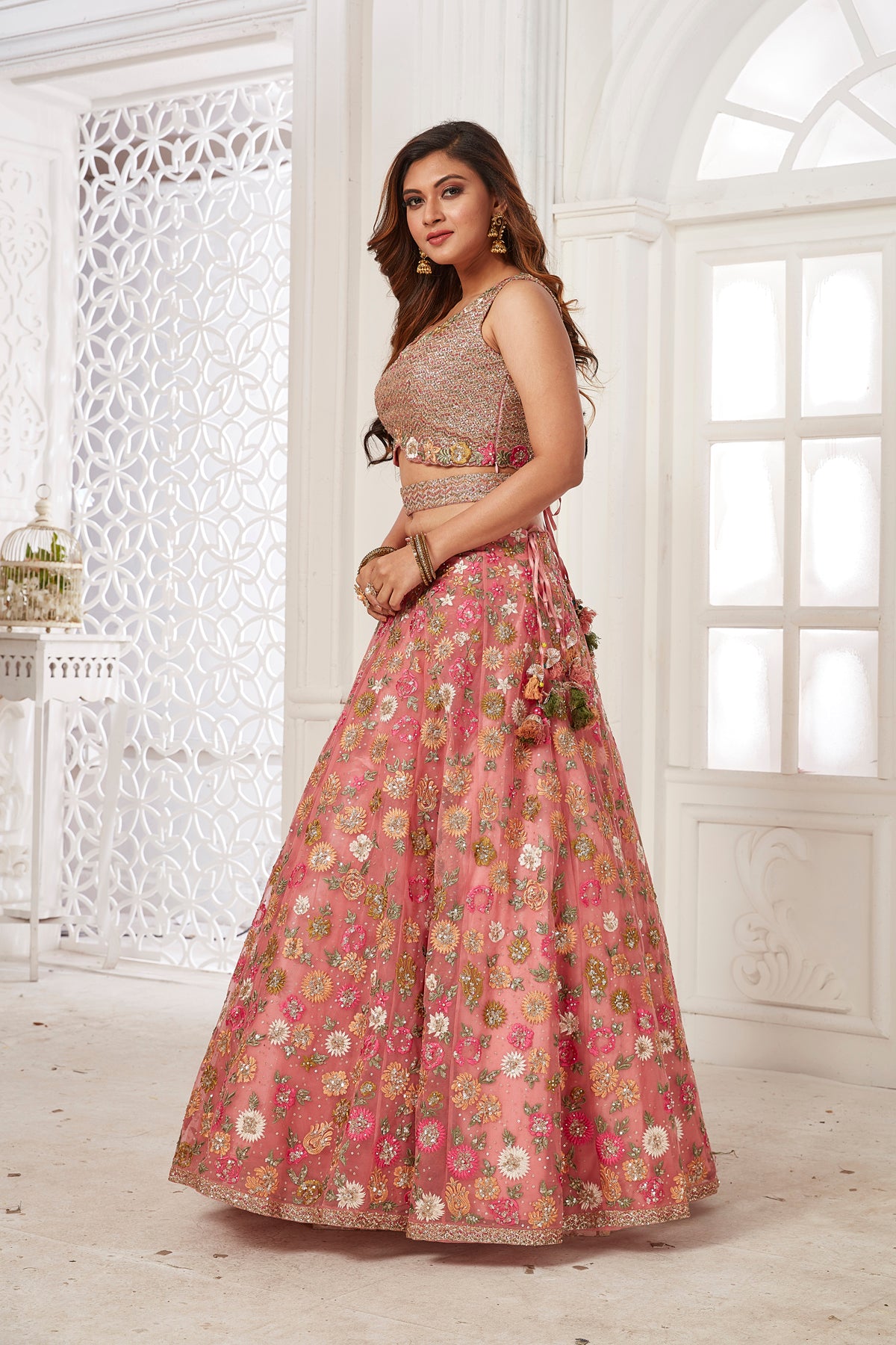 Buy stunning pink embroidered net lehenga online in USA with dupatta. Dazzle at weddings and parties in exquisite Indian designerwear dresses, designer lehengas, Anarkali suits, gowns, palazzo suits, sharara suits from Pure Elegance Indian fashion store in USA.-left