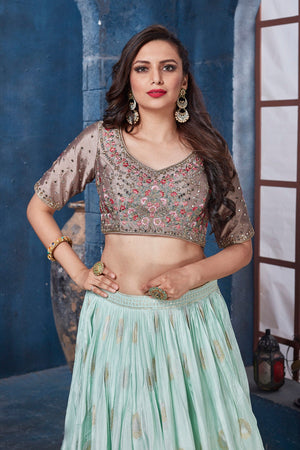 Shop beige and mint green embroidered designer lehenga online in USA. Get set for weddings and festive occasions in exclusive designer Anarkali suits, wedding gown, salwar suits, gharara suits, Indowestern dresses from Pure Elegance Indian fashion store in USA.-closeup