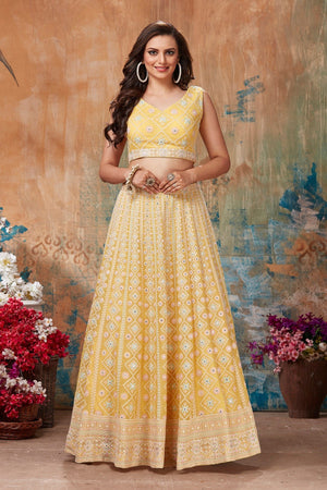 Shop gorgeous yellow embroidered designer lehenga online in USA with cape style dupatta. Get set for weddings and festive occasions in exclusive designer Anarkali suits, wedding gown, salwar suits, gharara suits, Indowestern dresses from Pure Elegance Indian fashion store in USA.-front