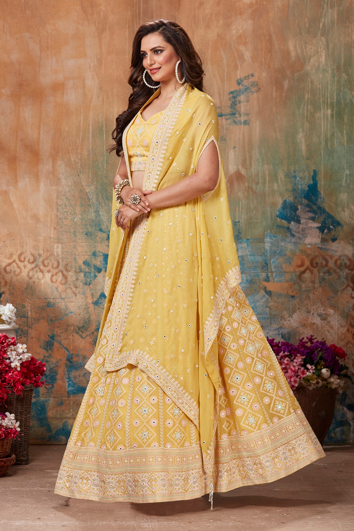 Shop gorgeous yellow embroidered designer lehenga online in USA with cape style dupatta. Get set for weddings and festive occasions in exclusive designer Anarkali suits, wedding gown, salwar suits, gharara suits, Indowestern dresses from Pure Elegance Indian fashion store in USA.-full view