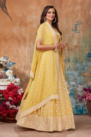 Shop gorgeous yellow embroidered designer lehenga online in USA with cape style dupatta. Get set for weddings and festive occasions in exclusive designer Anarkali suits, wedding gown, salwar suits, gharara suits, Indowestern dresses from Pure Elegance Indian fashion store in USA.-left