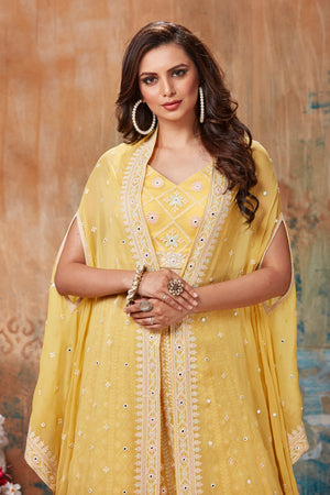Shop gorgeous yellow embroidered designer lehenga online in USA with cape style dupatta. Get set for weddings and festive occasions in exclusive designer Anarkali suits, wedding gown, salwar suits, gharara suits, Indowestern dresses from Pure Elegance Indian fashion store in USA.-closeup