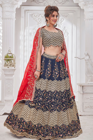 Shop gorgeous blue embroidered designer lehenga online in USA with red dupatta. Get set for weddings and festive occasions in exclusive designer Anarkali suits, wedding gown, salwar suits, gharara suits, Indowestern dresses from Pure Elegance Indian fashion store in USA.-left