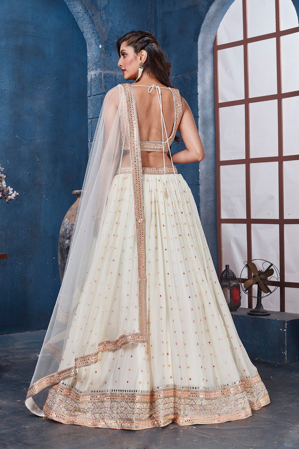 Shop off-white embroidered designer lehenga online in USA with dupatta. Get set for weddings and festive occasions in exclusive designer Anarkali suits, wedding gown, salwar suits, gharara suits, Indowestern dresses from Pure Elegance Indian fashion store in USA.-back
