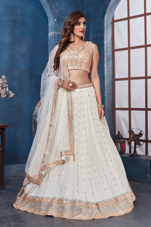 Shop off-white embroidered designer lehenga online in USA with dupatta. Get set for weddings and festive occasions in exclusive designer Anarkali suits, wedding gown, salwar suits, gharara suits, Indowestern dresses from Pure Elegance Indian fashion store in USA.-front
