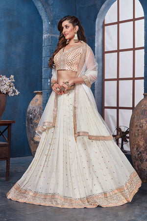 Shop off-white embroidered designer lehenga online in USA with dupatta. Get set for weddings and festive occasions in exclusive designer Anarkali suits, wedding gown, salwar suits, gharara suits, Indowestern dresses from Pure Elegance Indian fashion store in USA.-side