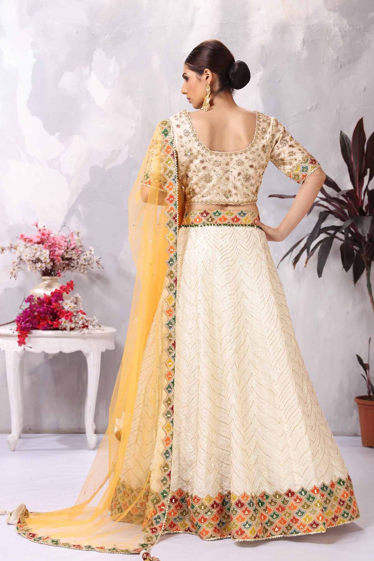 Shop gorgeous off-white embroidered belted designer lehenga online in USA. Be the center of attraction on special occasion in beautiful designer lehengas, bridal lehengas, palazzo suits, sharara suits, Anarkali suits, gowns from Pure Elegance Indian fashion store in USA.-back