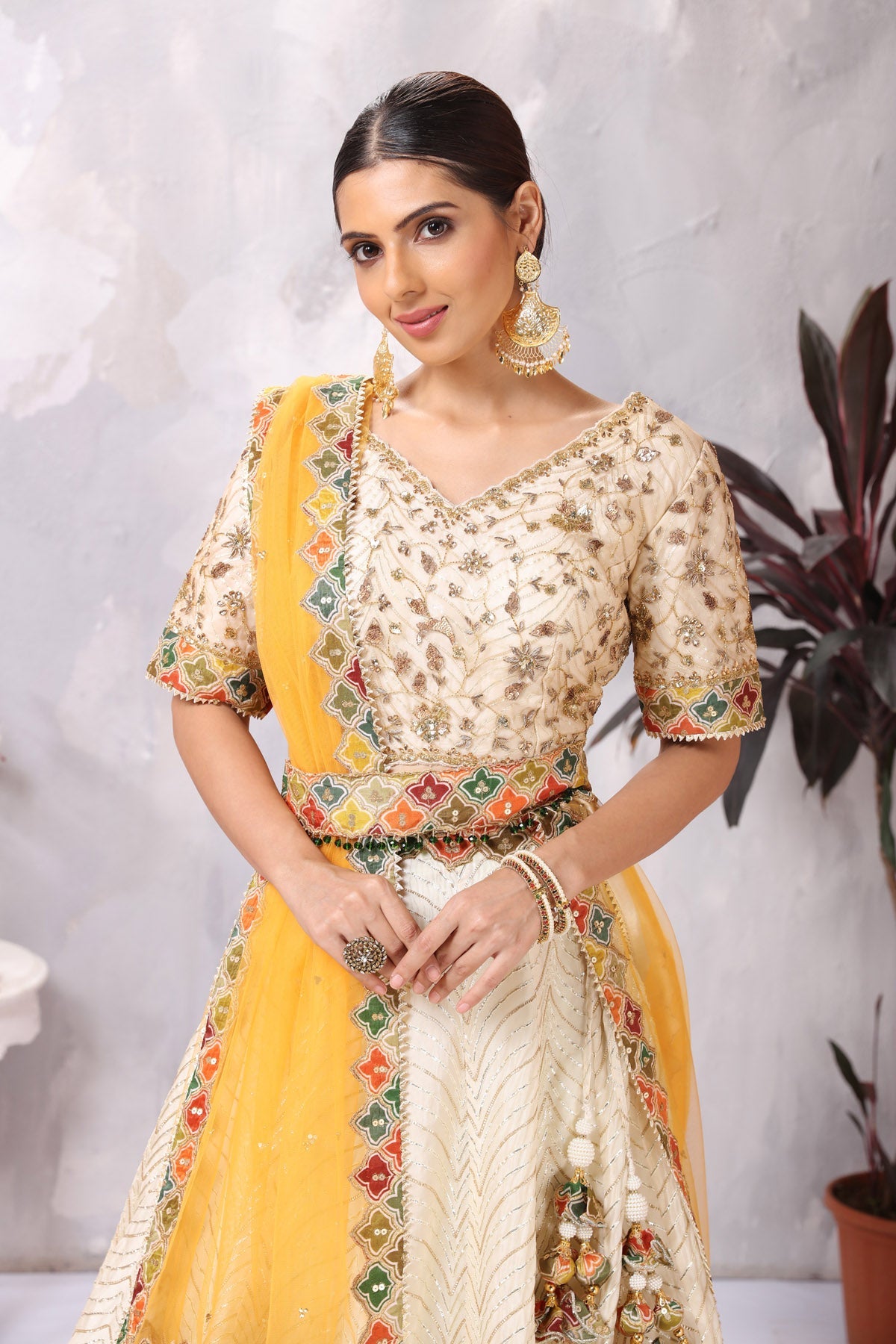 Shop gorgeous off-white embroidered belted designer lehenga online in USA. Be the center of attraction on special occasion in beautiful designer lehengas, bridal lehengas, palazzo suits, sharara suits, Anarkali suits, gowns from Pure Elegance Indian fashion store in USA.-closeup