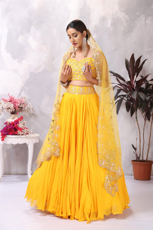 Buy stunning yellow embroidered designer lehenga online in USA with dupatta. Be the center of attraction on special occasion in beautiful designer lehengas, bridal lehengas, palazzo suits, sharara suits, Anarkali suits, gowns from Pure Elegance Indian fashion store in USA.-front
