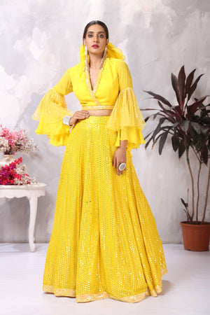 Buy stunning yellow designer lehenga online in USA with bell sleeves blouse. Be the center of attraction on special occasion in beautiful designer lehengas, bridal lehengas, palazzo suits, sharara suits, Anarkali suits, gowns from Pure Elegance Indian fashion store in USA.-blouse