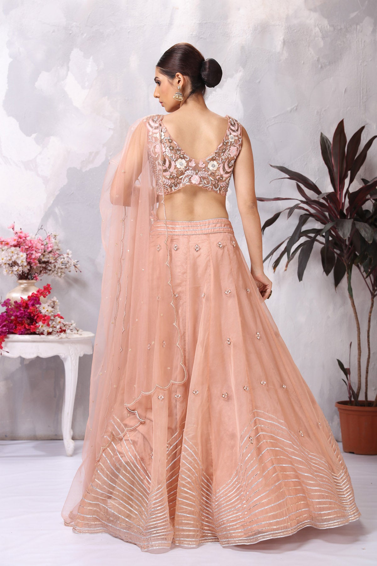 Shop peach embroidered designer lehenga online in USA with dupatta. Be the center of attraction on special occasion in beautiful designer lehengas, bridal lehengas, palazzo suits, sharara suits, Anarkali suits, gowns from Pure Elegance Indian fashion store in USA.-back