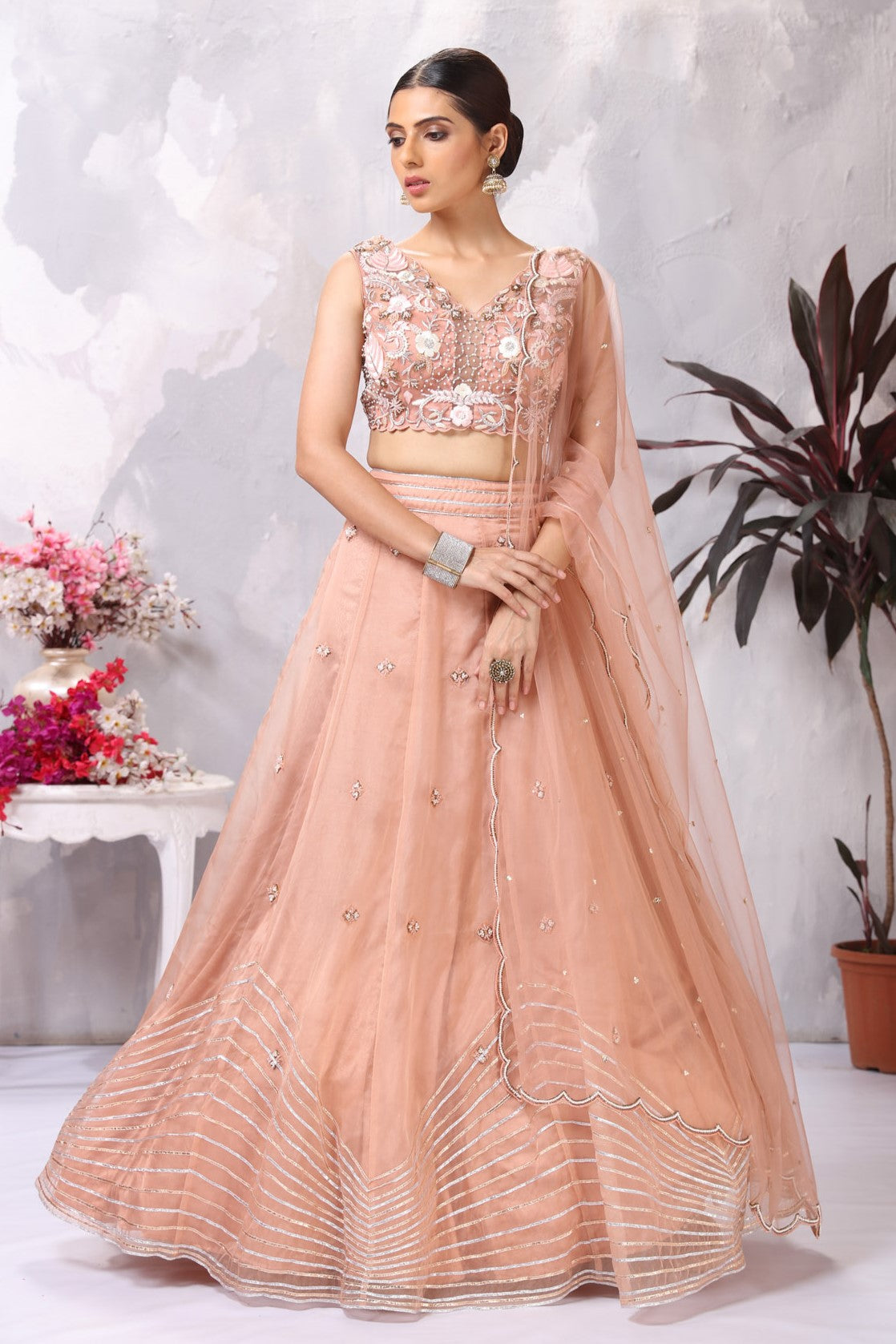 Shop peach embroidered designer lehenga online in USA with dupatta. Be the center of attraction on special occasion in beautiful designer lehengas, bridal lehengas, palazzo suits, sharara suits, Anarkali suits, gowns from Pure Elegance Indian fashion store in USA.-full view