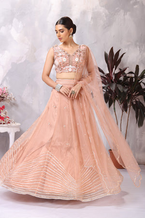 Shop peach embroidered designer lehenga online in USA with dupatta. Be the center of attraction on special occasion in beautiful designer lehengas, bridal lehengas, palazzo suits, sharara suits, Anarkali suits, gowns from Pure Elegance Indian fashion store in USA.-lehenga
