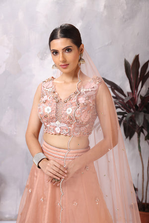 Shop peach embroidered designer lehenga online in USA with dupatta. Be the center of attraction on special occasion in beautiful designer lehengas, bridal lehengas, palazzo suits, sharara suits, Anarkali suits, gowns from Pure Elegance Indian fashion store in USA.-closeup