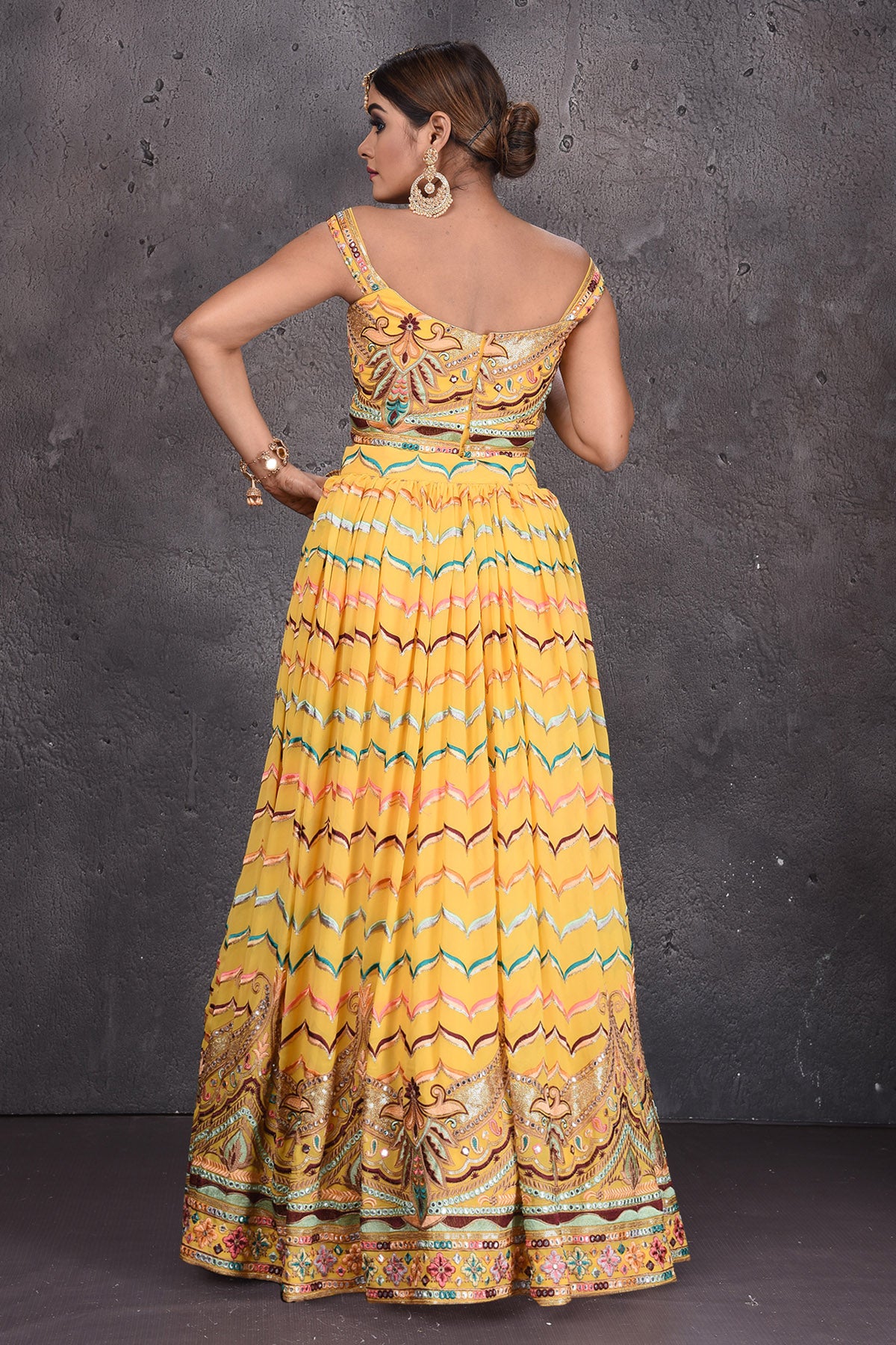 Buy stunning yellow embroidered off-shoulder designer lehenga online in USA with dupatta. Radiate ethnic glam on special occasions in beautiful designer lehengas, Anarkali suits, Indowestern dresses, designer gown, salwar suits from Pure Elegance Indian fashion store in USA,-back