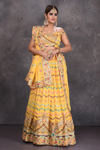 Buy stunning yellow embroidered off-shoulder designer lehenga online in USA with dupatta. Radiate ethnic glam on special occasions in beautiful designer lehengas, Anarkali suits, Indowestern dresses, designer gown, salwar suits from Pure Elegance Indian fashion store in USA,-full view