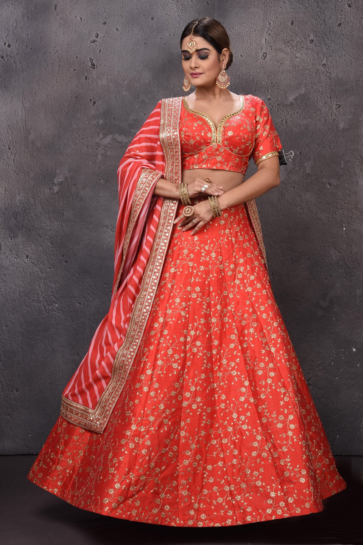 Buy beautiful orange embroidered designer lehenga with striped dupatta. Look royal at weddings in this bespoke designer lehengas, wedding gowns, bridal lehengas, designer sarees, Anarkali suits, sharara suits, from Pure Elegance Indian fashion store in USA.-full view