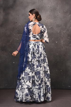 Buy beautiful white and blue printed lehenga online in USA with blue dupatta. Get set for weddings and festive occasions in exclusive designer Anarkali suits, wedding gown, salwar suits, gharara suits, Indowestern dresses from Pure Elegance Indian fashion store in USA.-back