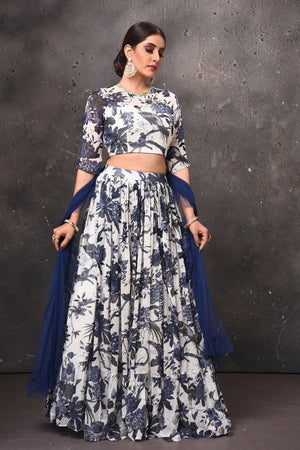 Buy beautiful white and blue printed lehenga online in USA with blue dupatta. Get set for weddings and festive occasions in exclusive designer Anarkali suits, wedding gown, salwar suits, gharara suits, Indowestern dresses from Pure Elegance Indian fashion store in USA.-side