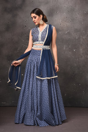 Shop stunning blue printed lehenga online in USA with embellished belt. Get set for weddings and festive occasions in exclusive designer Anarkali suits, wedding gown, salwar suits, gharara suits, Indowestern dresses from Pure Elegance Indian fashion store in USA.-front