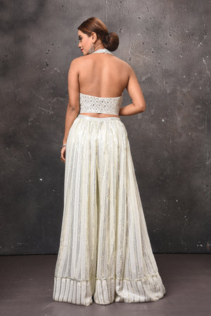 Buy beautiful off-white embellished halter neck top online in USA with skirt. Get set for weddings and festive occasions in exclusive designer Anarkali suits, wedding gown, salwar suits, gharara suits, Indowestern dresses from Pure Elegance Indian fashion store in USA.-back