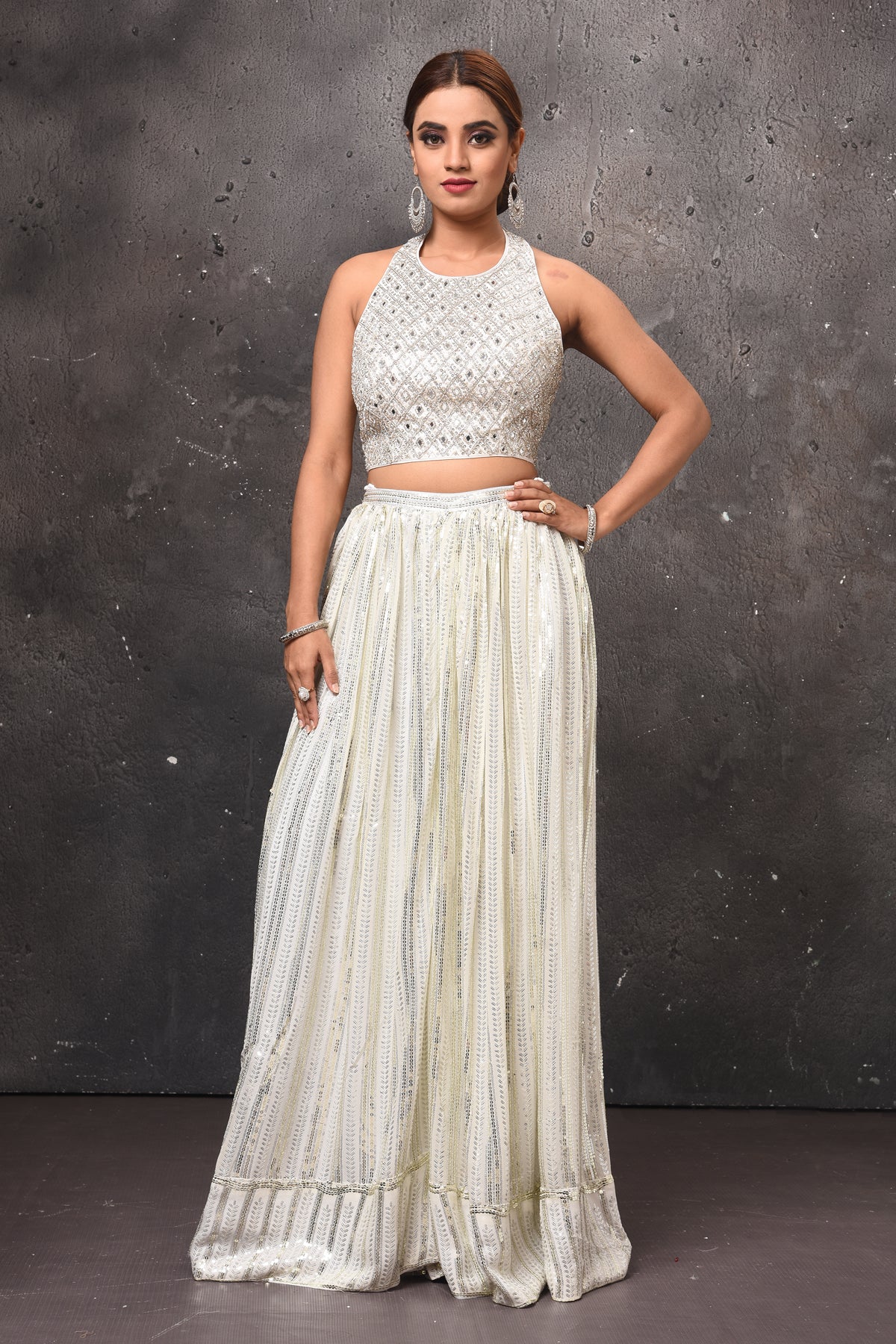 Buy beautiful off-white embellished halter neck top online in USA with skirt. Get set for weddings and festive occasions in exclusive designer Anarkali suits, wedding gown, salwar suits, gharara suits, Indowestern dresses from Pure Elegance Indian fashion store in USA.-full view