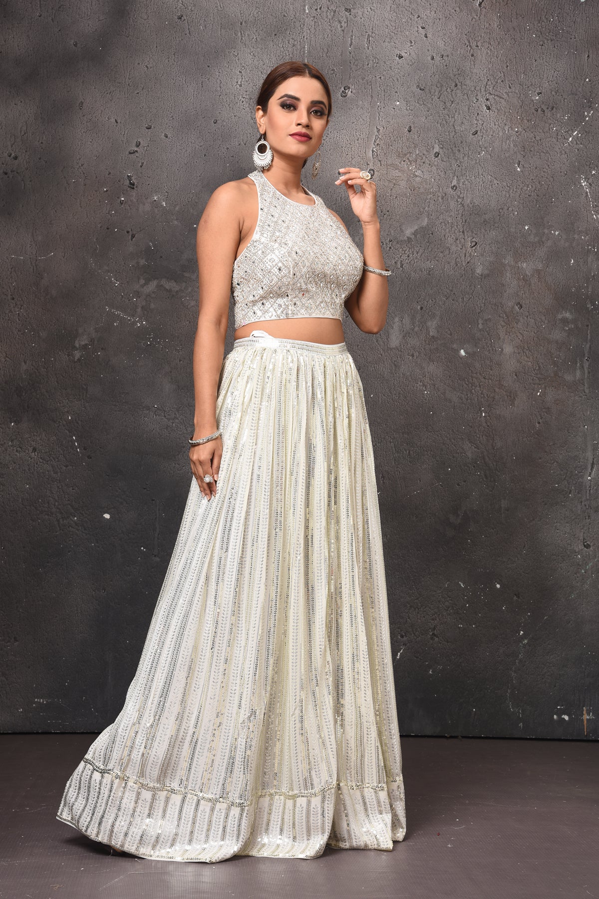 Buy beautiful off-white embellished halter neck top online in USA with skirt. Get set for weddings and festive occasions in exclusive designer Anarkali suits, wedding gown, salwar suits, gharara suits, Indowestern dresses from Pure Elegance Indian fashion store in USA.-side