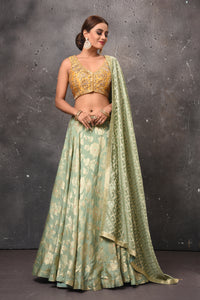 Buy beautiful pastel green and golden designer lehenga online in USA with dupatta. Get set for weddings and festive occasions in exclusive designer Anarkali suits, wedding gown, salwar suits, gharara suits, Indowestern dresses from Pure Elegance Indian fashion store in USA.-full view