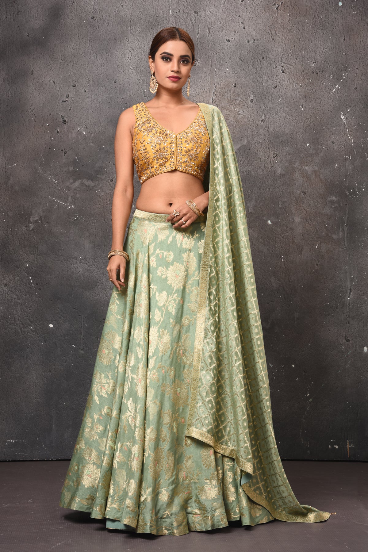 Buy beautiful pastel green and golden designer lehenga online in USA with dupatta. Get set for weddings and festive occasions in exclusive designer Anarkali suits, wedding gown, salwar suits, gharara suits, Indowestern dresses from Pure Elegance Indian fashion store in USA.-front