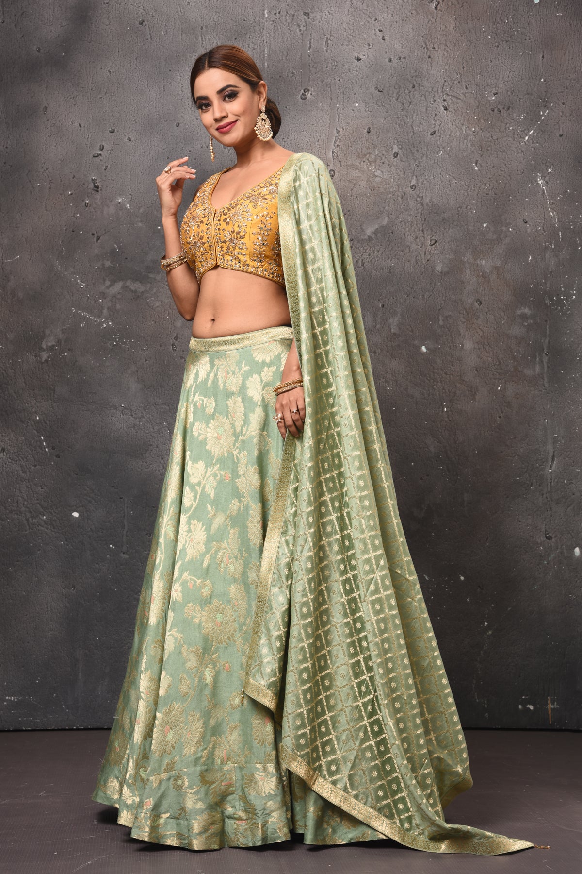 Buy beautiful pastel green and golden designer lehenga online in USA with dupatta. Get set for weddings and festive occasions in exclusive designer Anarkali suits, wedding gown, salwar suits, gharara suits, Indowestern dresses from Pure Elegance Indian fashion store in USA.-side