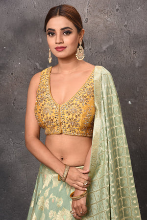 Buy beautiful pastel green and golden designer lehenga online in USA with dupatta. Get set for weddings and festive occasions in exclusive designer Anarkali suits, wedding gown, salwar suits, gharara suits, Indowestern dresses from Pure Elegance Indian fashion store in USA.-closeup