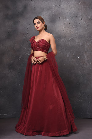 Buy stunning maroon one shoulder contemporary lehenga online in USA with dupatta. Get set for weddings and festive occasions in exclusive designer Anarkali suits, wedding gown, salwar suits, gharara suits, Indowestern dresses from Pure Elegance Indian fashion store in USA.-side