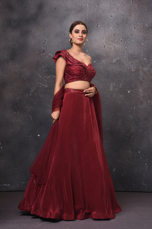 Buy stunning maroon one shoulder contemporary lehenga online in USA with dupatta. Get set for weddings and festive occasions in exclusive designer Anarkali suits, wedding gown, salwar suits, gharara suits, Indowestern dresses from Pure Elegance Indian fashion store in USA.-right
