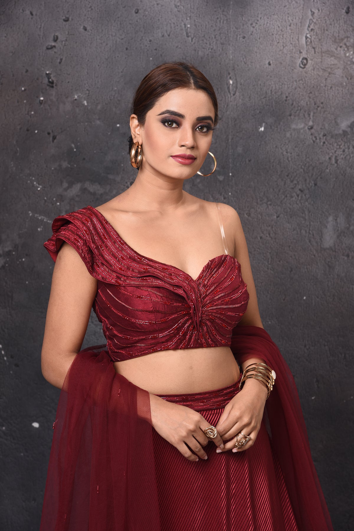 Buy stunning maroon one shoulder contemporary lehenga online in USA with dupatta. Get set for weddings and festive occasions in exclusive designer Anarkali suits, wedding gown, salwar suits, gharara suits, Indowestern dresses from Pure Elegance Indian fashion store in USA.-closeup