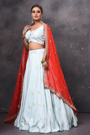 Buy stunning powder blue designer lehenga online in USA with red embroidered dupatta. Get set for weddings and festive occasions in exclusive designer Anarkali suits, wedding gown, salwar suits, gharara suits, Indowestern dresses from Pure Elegance Indian fashion store in USA.-left