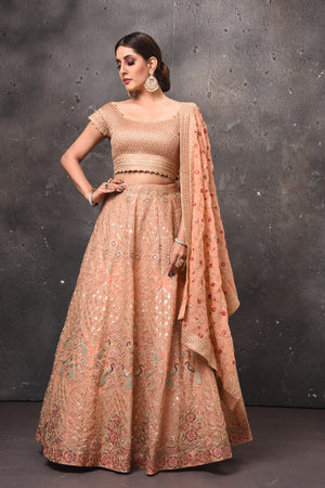 Shop beautiful peach embroidered designer lehenga online in USA with dupatta. Get set for weddings and festive occasions in exclusive designer Anarkali suits, wedding gown, salwar suits, gharara suits, Indowestern dresses from Pure Elegance Indian fashion store in USA.-front
