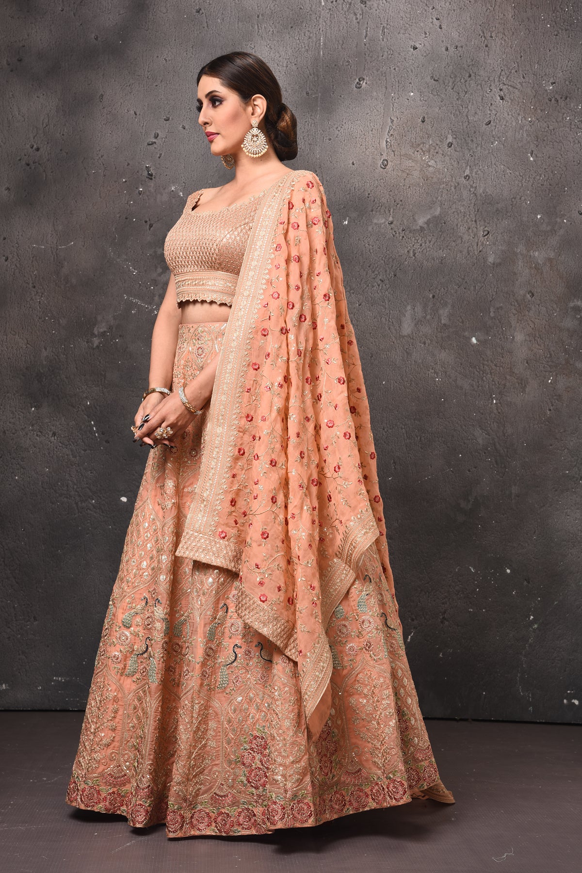 Shop beautiful peach embroidered designer lehenga online in USA with dupatta. Get set for weddings and festive occasions in exclusive designer Anarkali suits, wedding gown, salwar suits, gharara suits, Indowestern dresses from Pure Elegance Indian fashion store in USA.-left