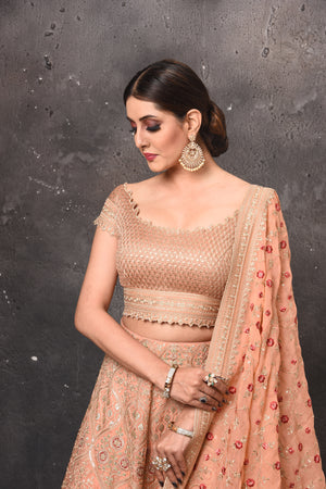 Shop beautiful peach embroidered designer lehenga online in USA with dupatta. Get set for weddings and festive occasions in exclusive designer Anarkali suits, wedding gown, salwar suits, gharara suits, Indowestern dresses from Pure Elegance Indian fashion store in USA.-closeup