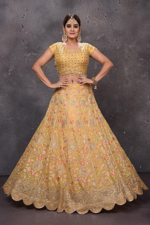 Buy stunning yellow embroidered designer lehenga online in USA with fancy dupatta. Get set for weddings and festive occasions in exclusive designer Anarkali suits, wedding gown, salwar suits, gharara suits, Indowestern dresses from Pure Elegance Indian fashion store in USA.-full view