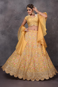 Buy stunning yellow embroidered designer lehenga online in USA with fancy dupatta. Get set for weddings and festive occasions in exclusive designer Anarkali suits, wedding gown, salwar suits, gharara suits, Indowestern dresses from Pure Elegance Indian fashion store in USA.-front