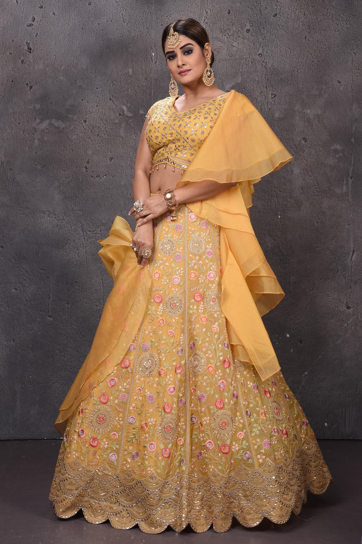 Buy stunning yellow embroidered designer lehenga online in USA with fancy dupatta. Get set for weddings and festive occasions in exclusive designer Anarkali suits, wedding gown, salwar suits, gharara suits, Indowestern dresses from Pure Elegance Indian fashion store in USA.-side