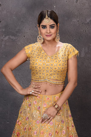 Buy stunning yellow embroidered designer lehenga online in USA with fancy dupatta. Get set for weddings and festive occasions in exclusive designer Anarkali suits, wedding gown, salwar suits, gharara suits, Indowestern dresses from Pure Elegance Indian fashion store in USA.-closeup