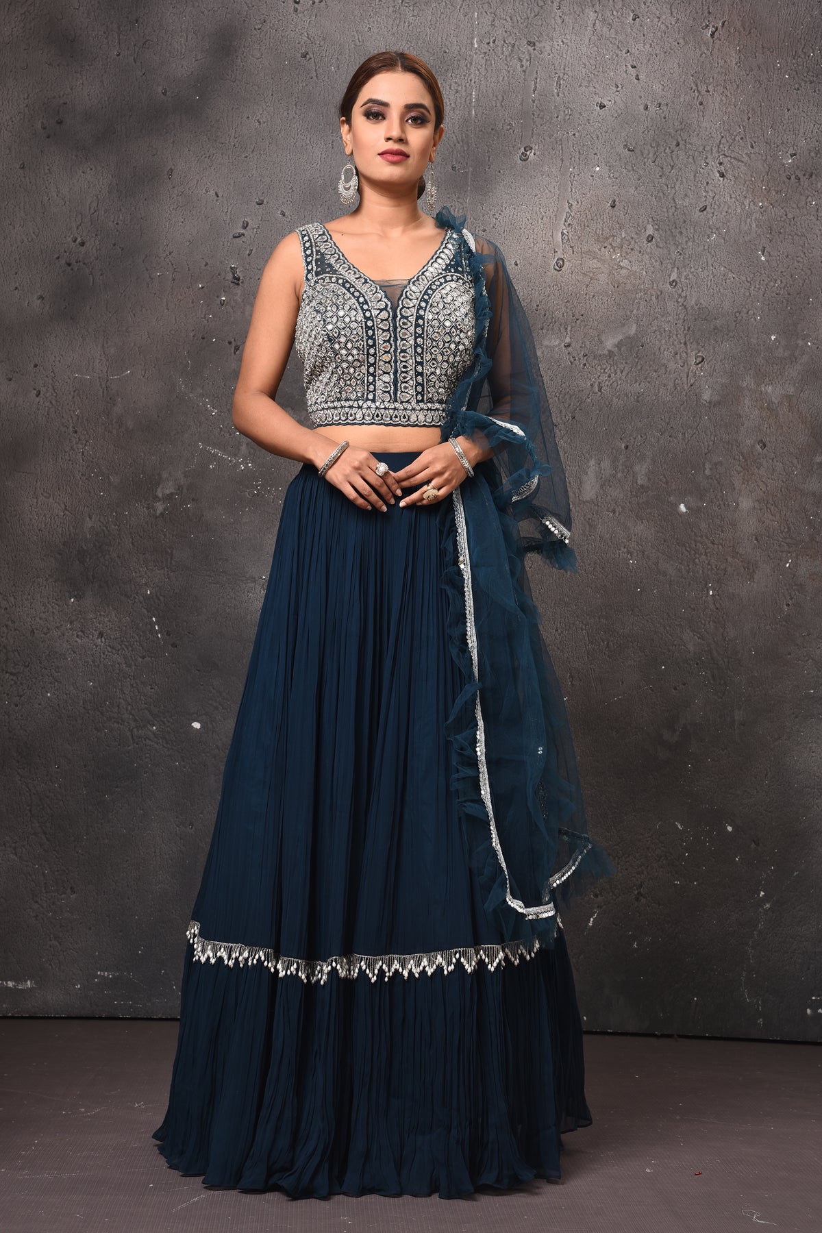 Shop stunning dark blue designer lehenga online in USA with ruffle dupatta. Get set for weddings and festive occasions in exclusive designer Anarkali suits, wedding gown, salwar suits, gharara suits, Indowestern dresses from Pure Elegance Indian fashion store in USA.-full view
