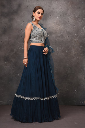 Shop stunning dark blue designer lehenga online in USA with ruffle dupatta. Get set for weddings and festive occasions in exclusive designer Anarkali suits, wedding gown, salwar suits, gharara suits, Indowestern dresses from Pure Elegance Indian fashion store in USA.-side